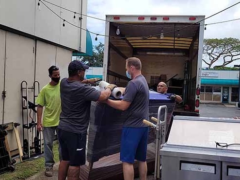 Honolulu courier and delivery service team loading an Oahu delivery truck.