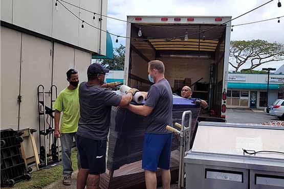 Honolulu courier and delivery service team loading an Oahu delivery truck.