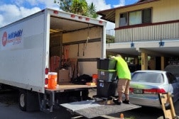 Honolulu movers loading furniture into a moving truck.